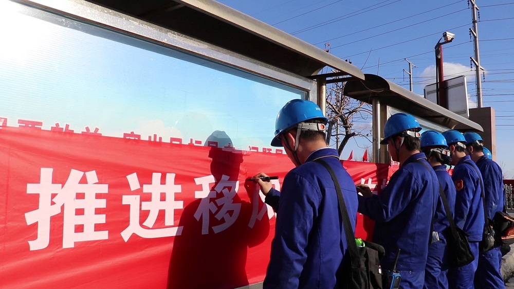 ”天能化工有限公司职工在文明祭扫横幅上签下自己的名字.jpg