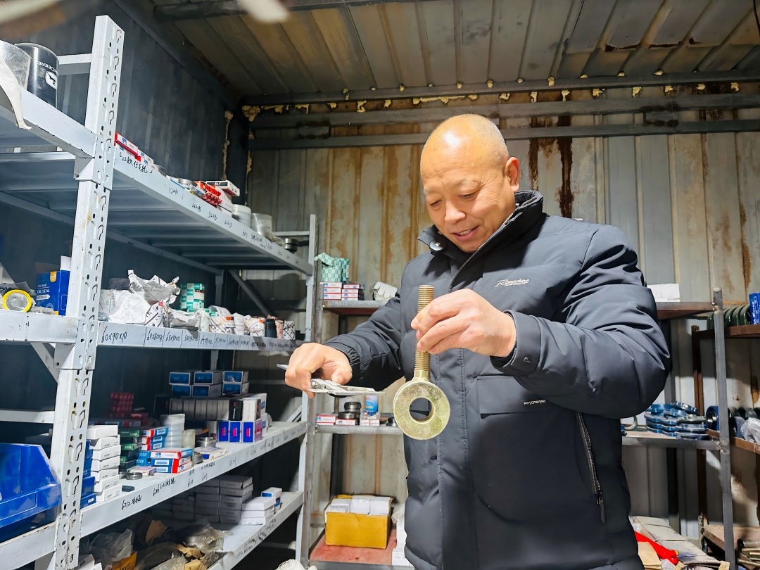 文长建正在他的工房测量配件。李萍 摄.jpg