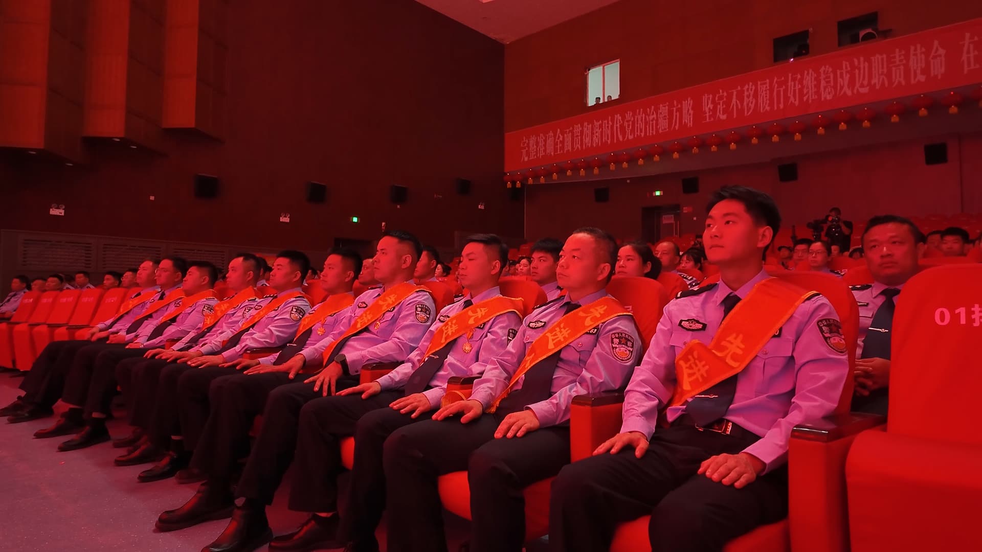 宣讲活动现场，身披荣誉绶带的公安英模代表端坐台下，认真聆听宣讲报告.jpg